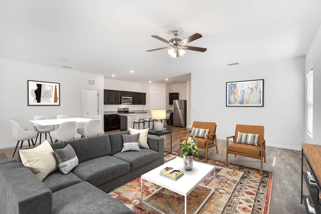 A living room with a grey couch and a white coffee table.