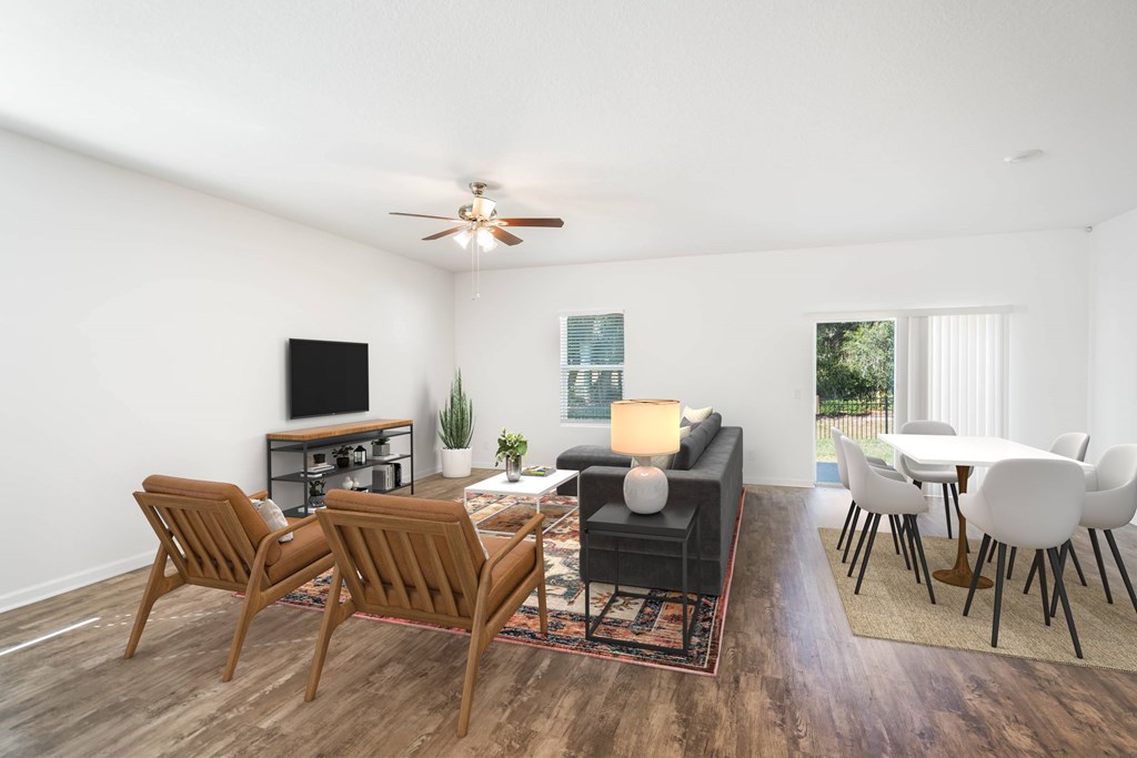 A living room with a brown chair and a black sofa.