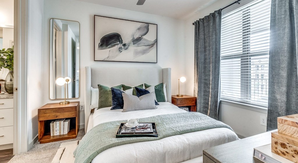 a bedroom with a bed and two windows