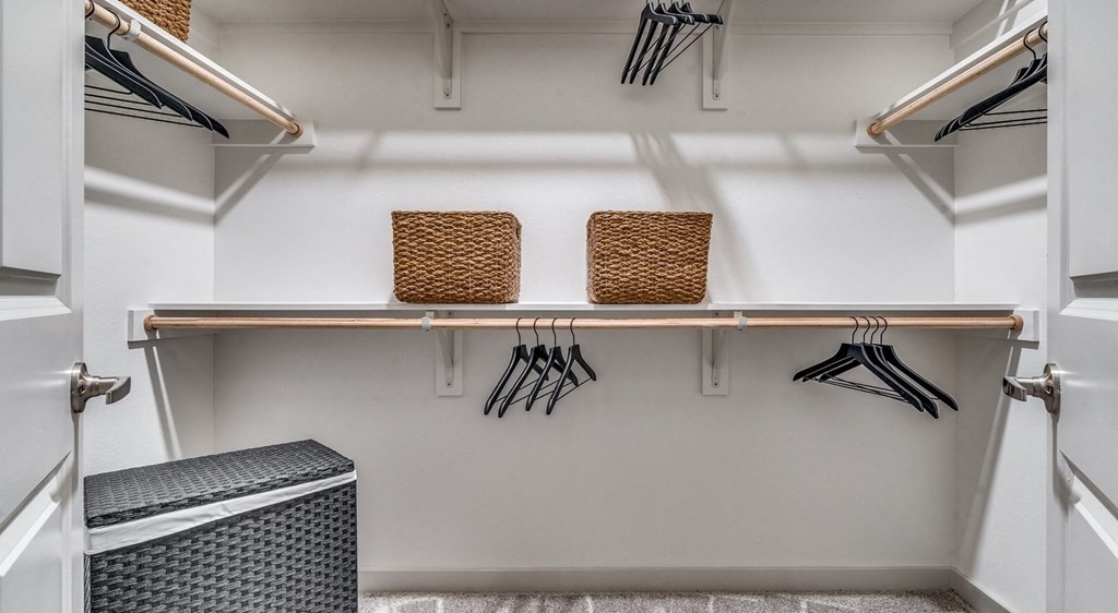 a walk in closet with a shelf and utensils