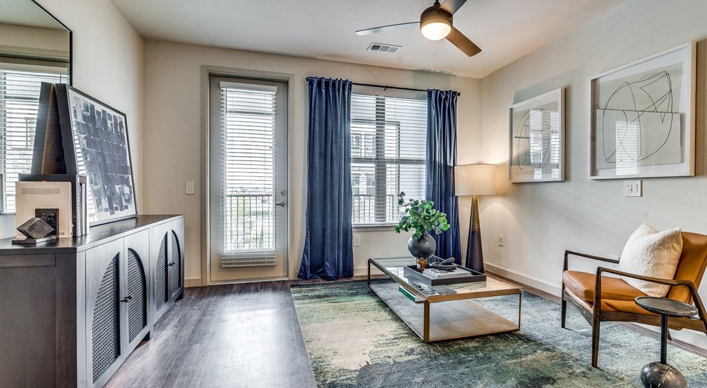 an empty living room with a fireplace and windows