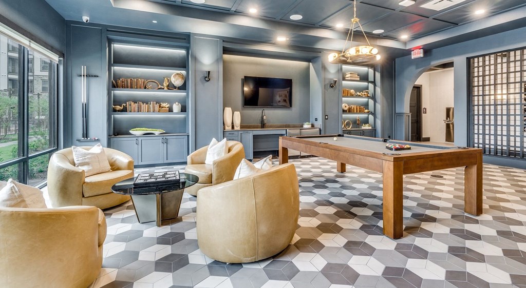 a game room with a pool table and a tv