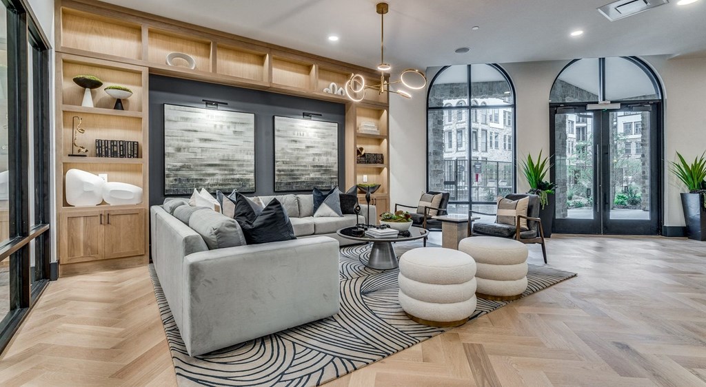 a living room with a gray couch and a zebra rug