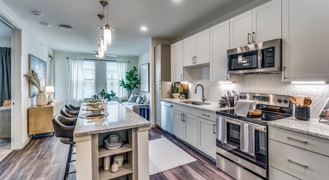a kitchen with stainless steel appliances and a marble counter top