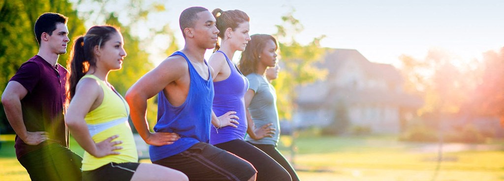 a group of people running in a park