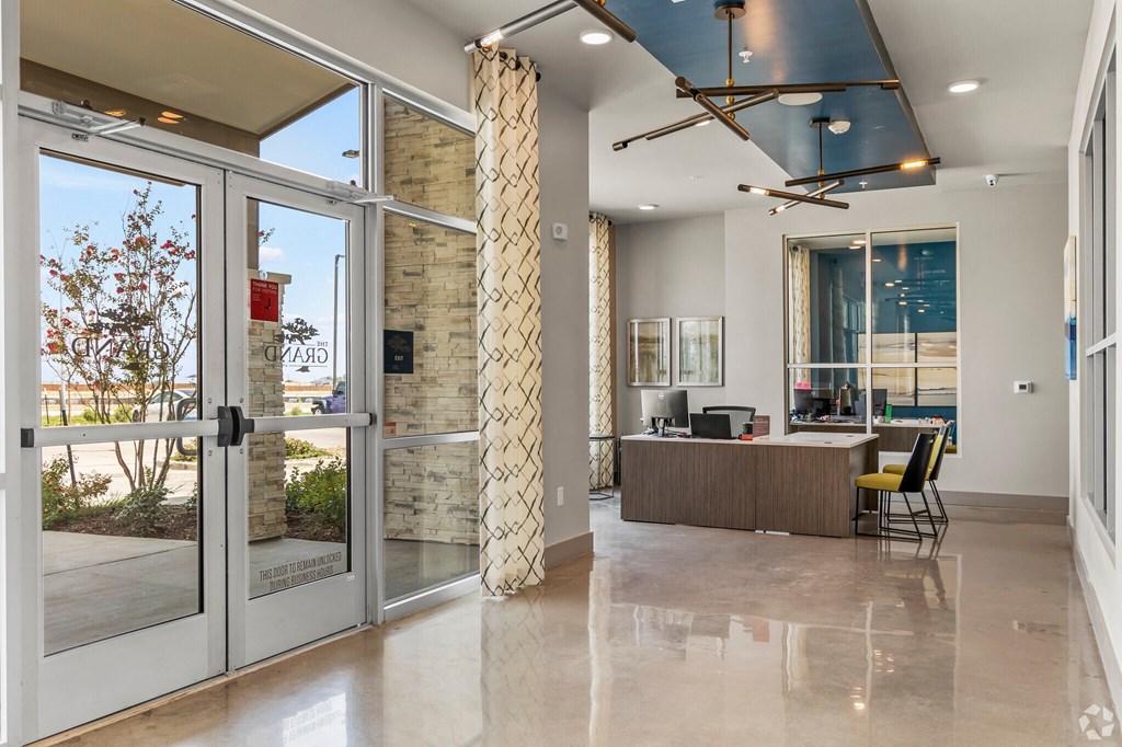 a view of the lobby with a reception desk and glass doors