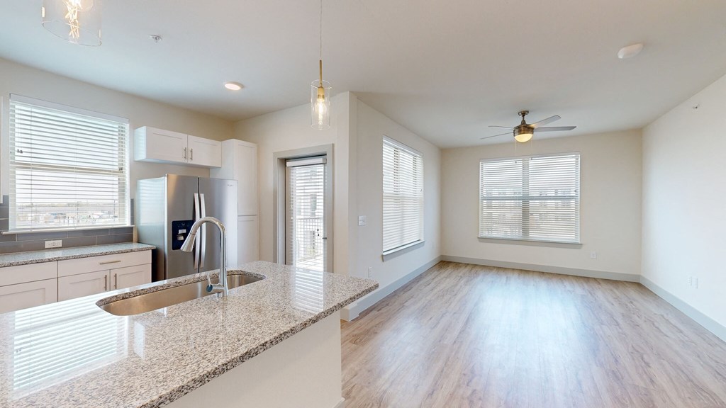 a kitchen and living room in an apartment