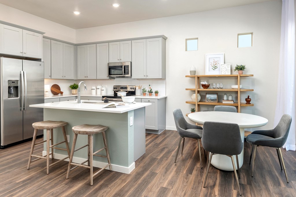 an open kitchen and dining area with a table and chairs