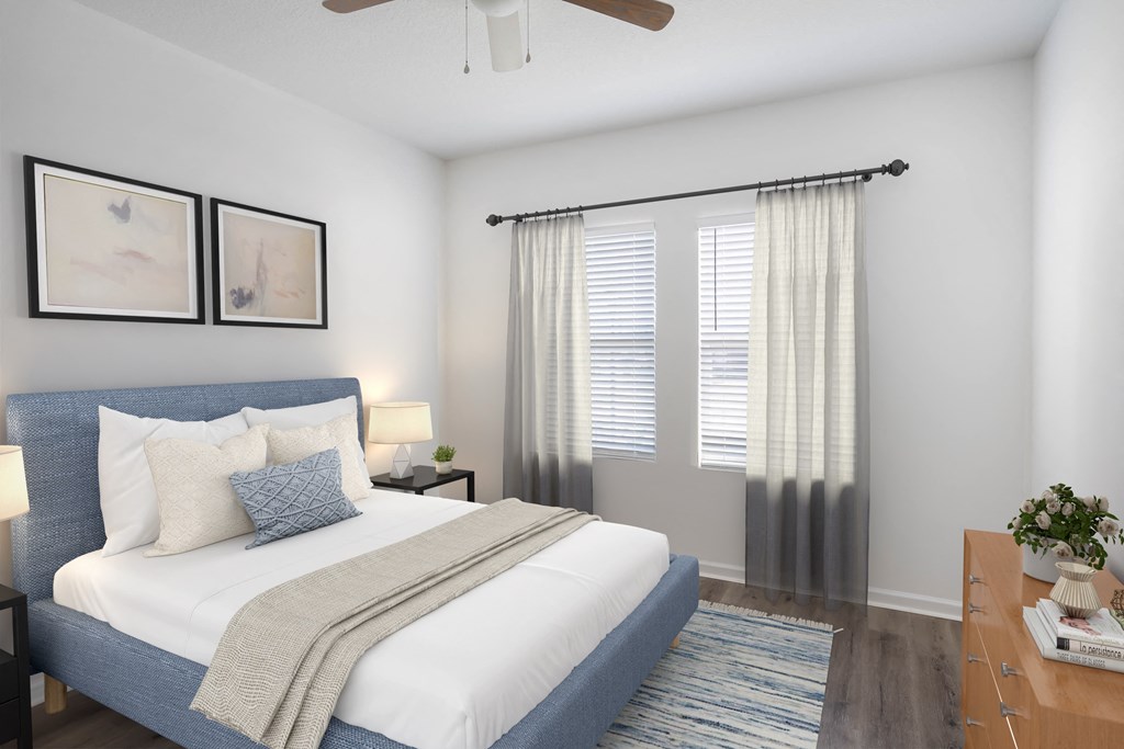 A bedroom with a bed, nightstand, and a ceiling fan.