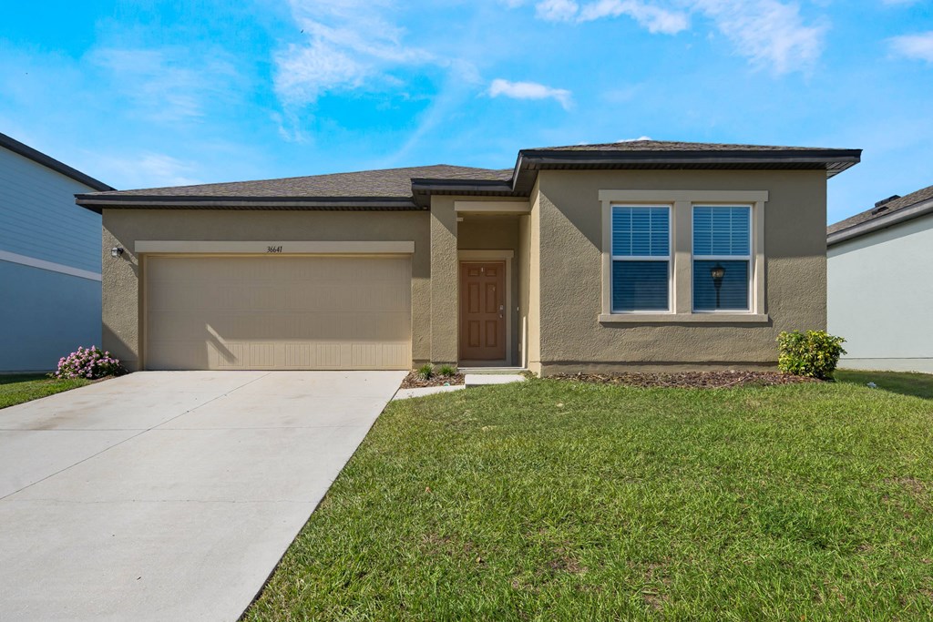 A house with a brown garage door and a brown window.