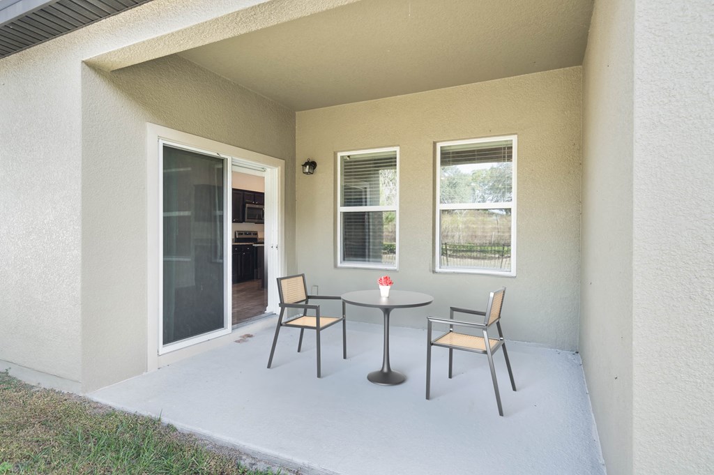 A patio with a table and chairs is shown.