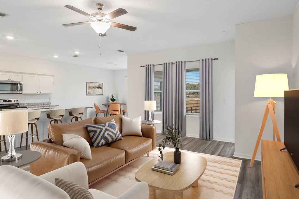 A living room with a brown leather couch and a wooden coffee table.