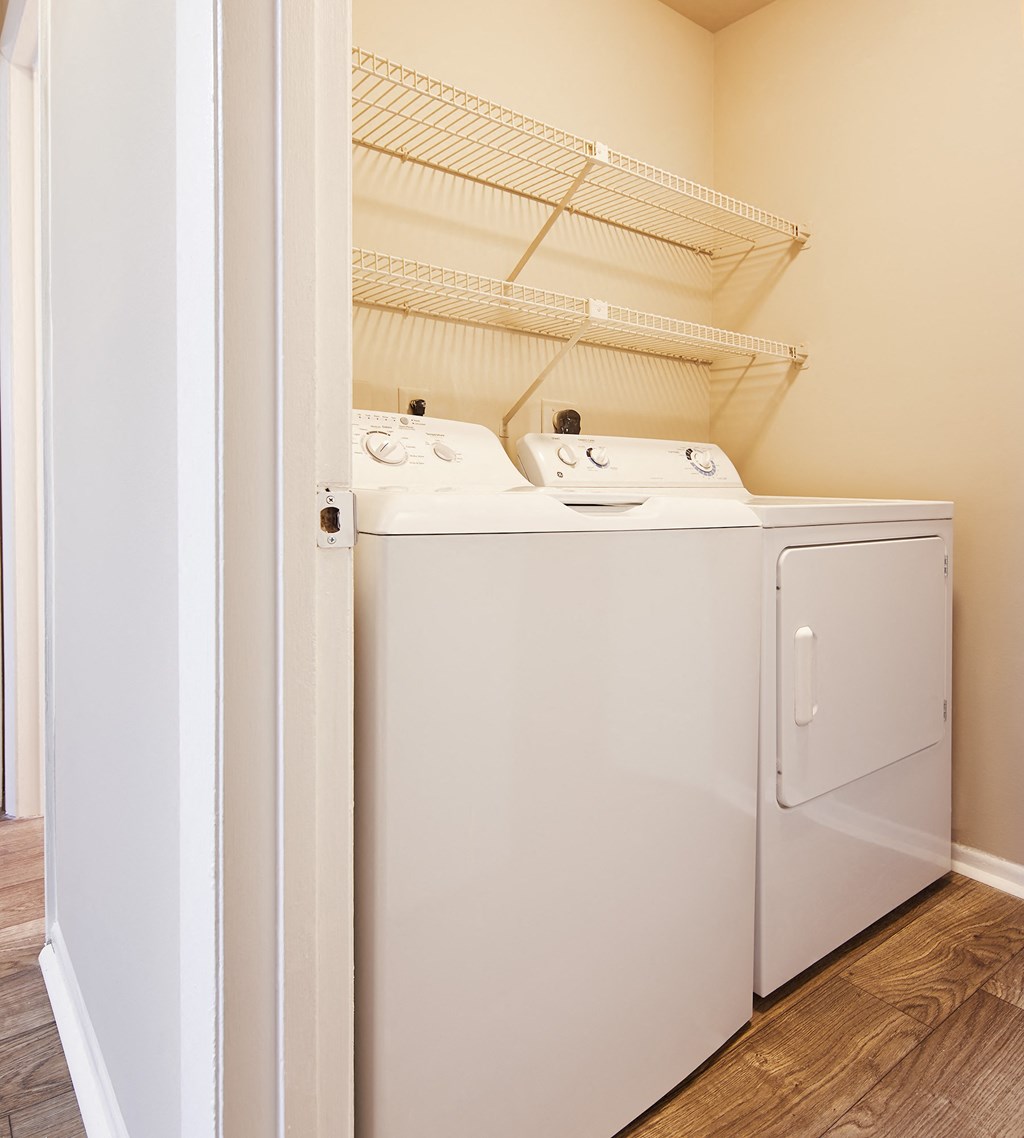 a washer and dryer in a laundry room with a door open
