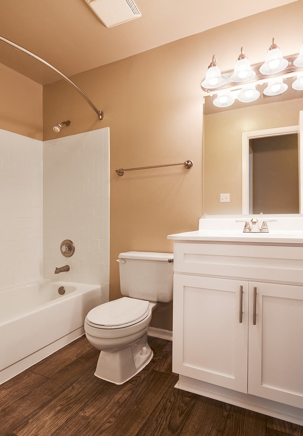 a bathroom with a toilet and a tub and a sink