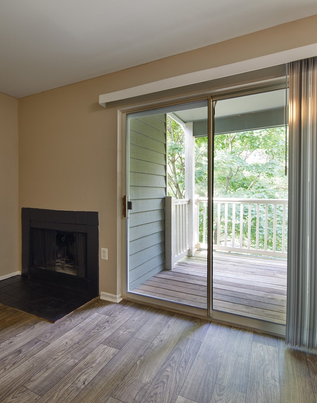 a living room with a fireplace and a sliding glass door