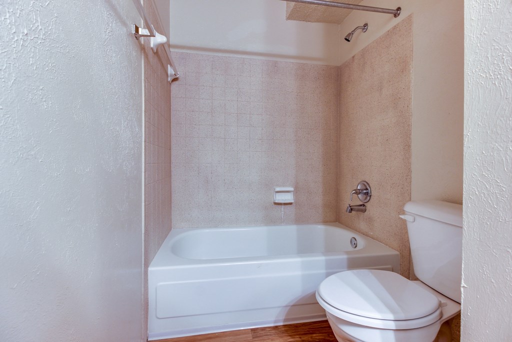 an empty bathroom with a toilet and a tub and a sink