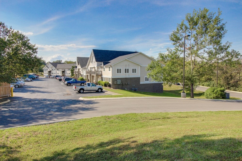 a neighborhood with houses and cars parked on a street