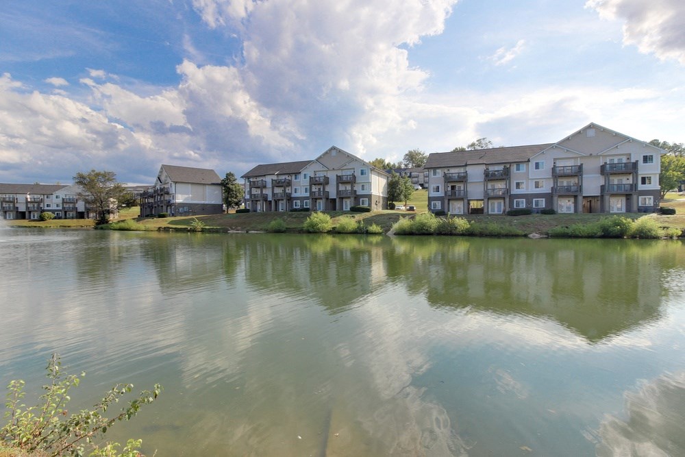 the view of an apartment building overlooking a lake