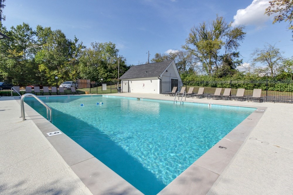a swimming pool with a house in the background