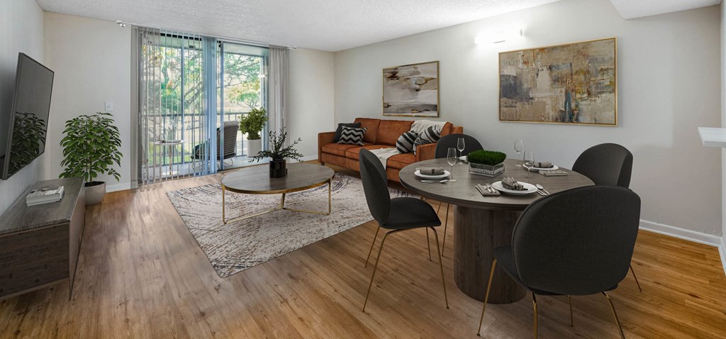 Modern apartment living room with dining area, balcony, and contemporary furnishings.