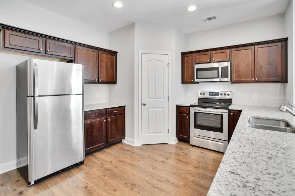 Harris Trail Luxury Townhomes for rent Richmond Hill, GA photo of kitchen with pantry and exspresso cabinets