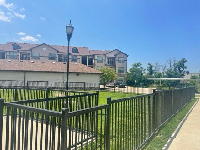 Parc at Bentonville Dog park with a metal fence around it