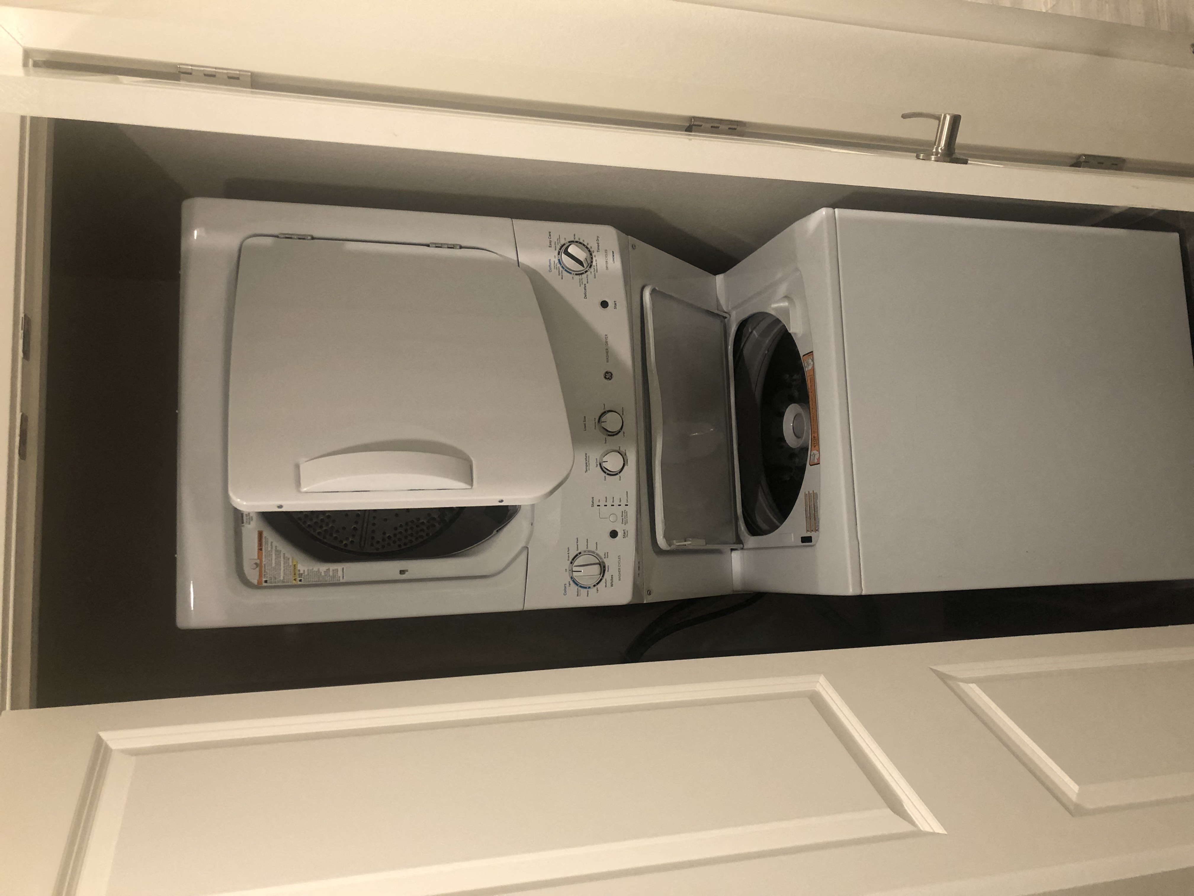 a microwave oven sitting inside of a cabinet