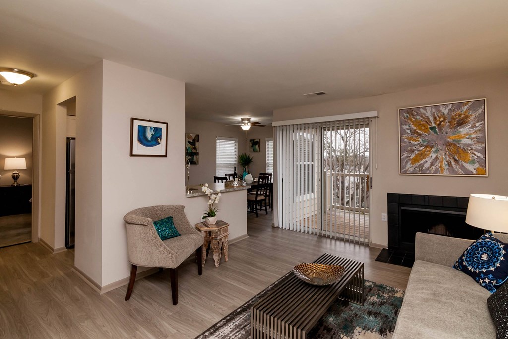 a living room with a couch and chairs and a fireplace