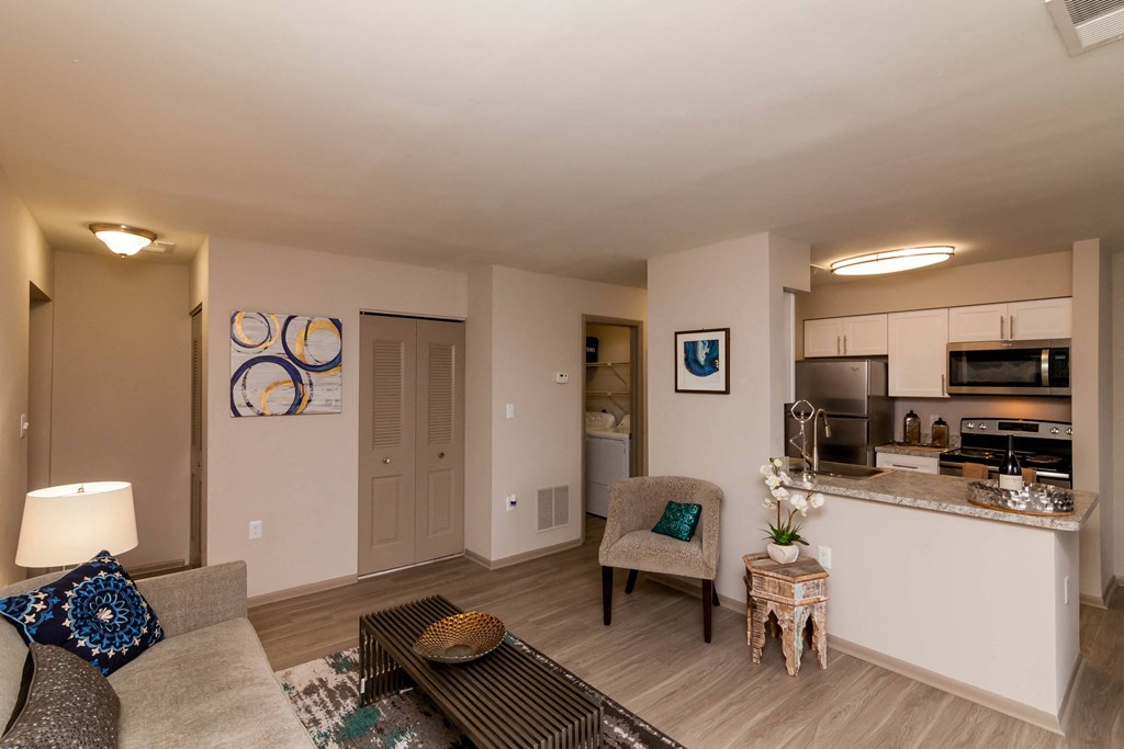 a living room and kitchen with a couch and a table