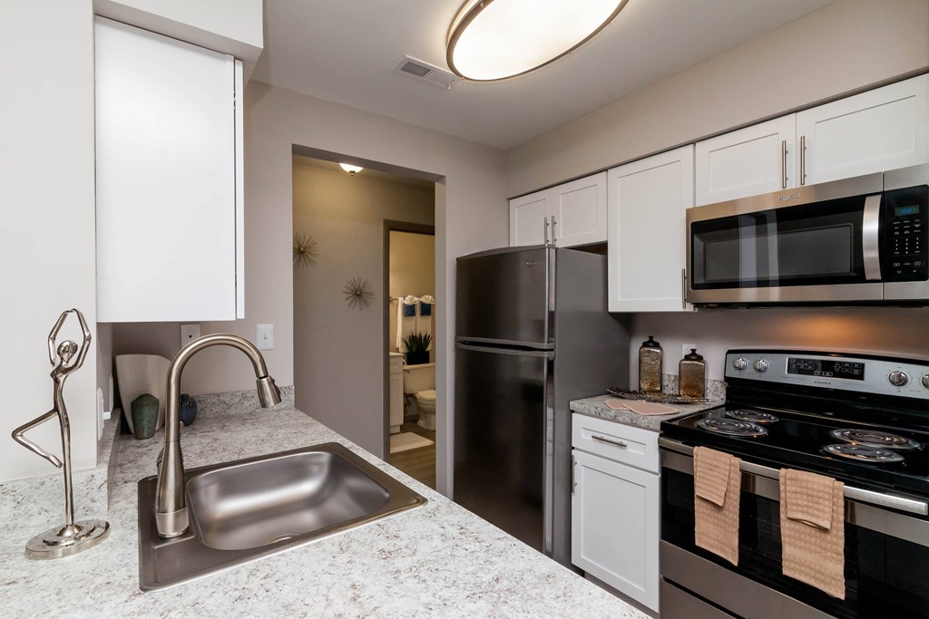 a kitchen with stainless steel appliances and granite counter tops