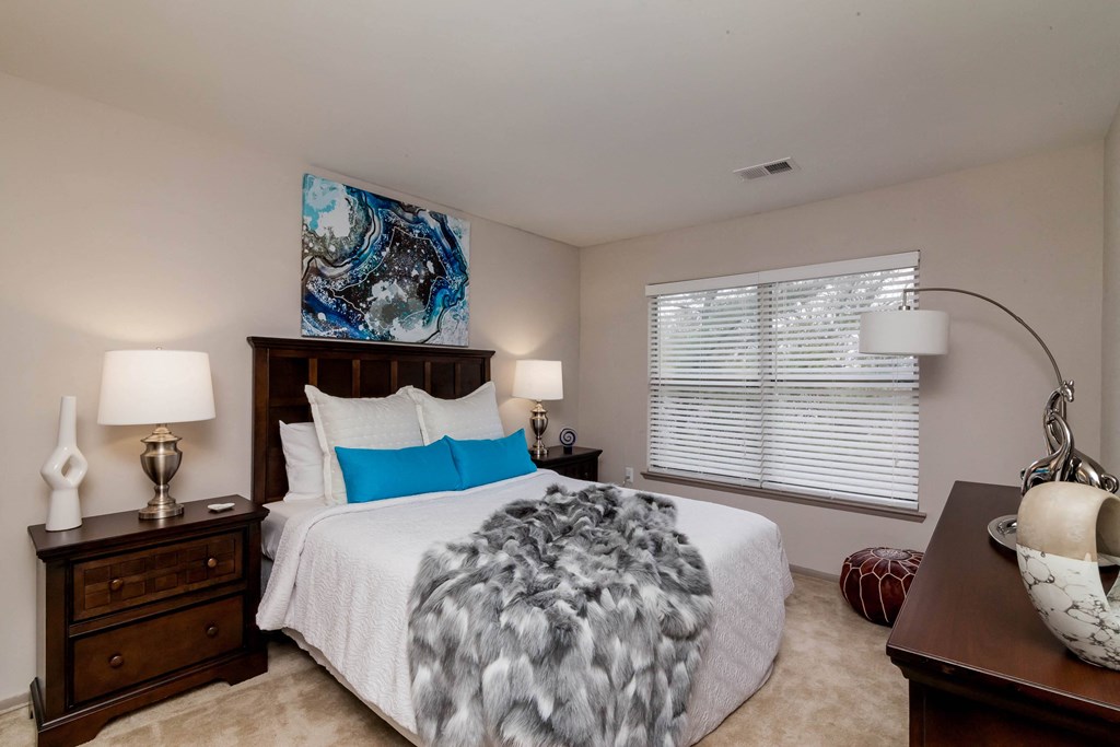 a bedroom with a large bed and a window