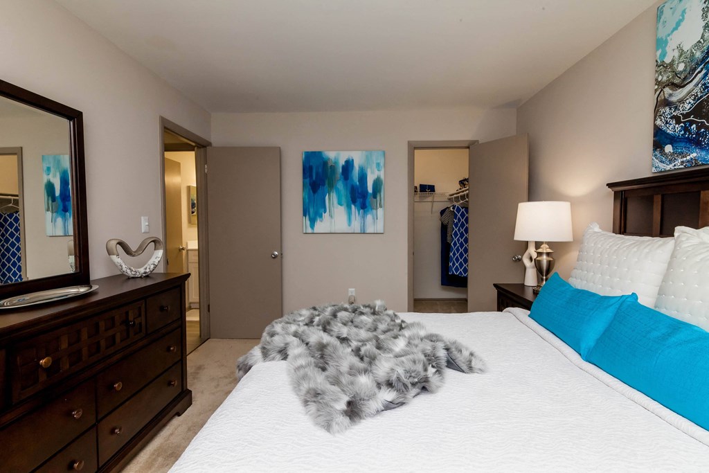 a bedroom with a large bed and a dresser