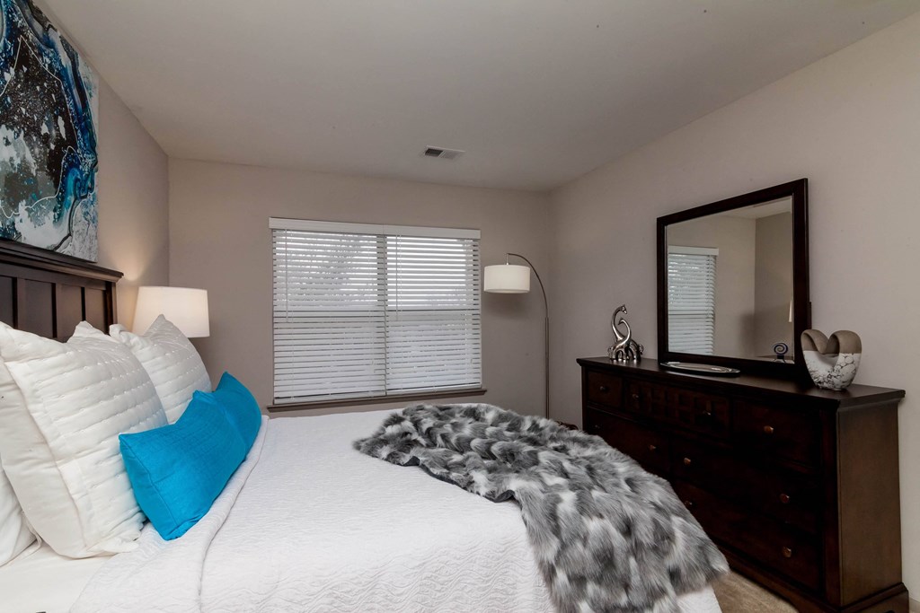 a bedroom with a large bed and a dresser