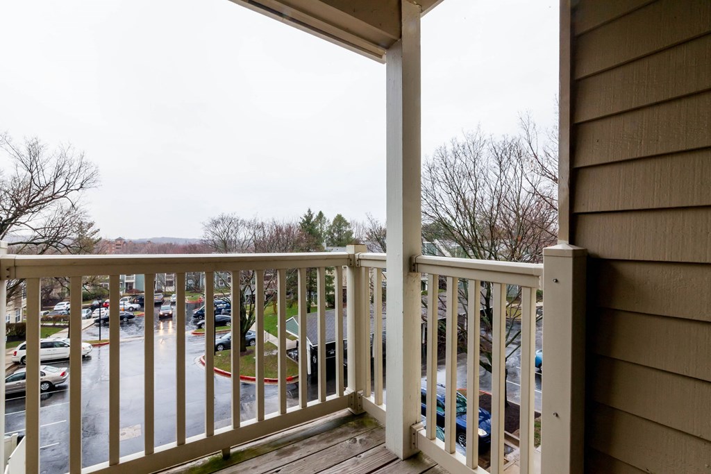 a balcony with a view of a parking lot