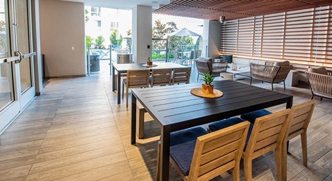 A dining room with a long table and chairs.