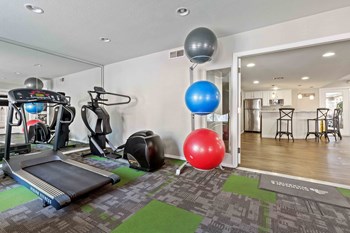 Glendale, AZ Apartments for Rent - Summerhill Place Fitness Center with exercise balls, a treadmill, and an elliptical