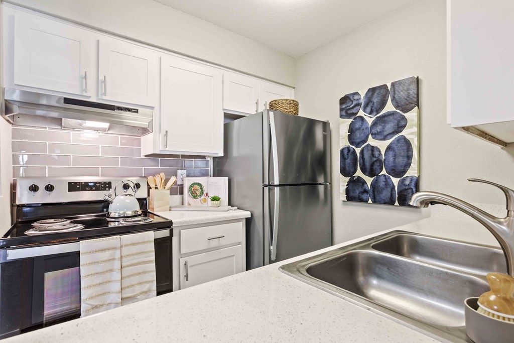 a kitchen with stainless steel appliances and a sink