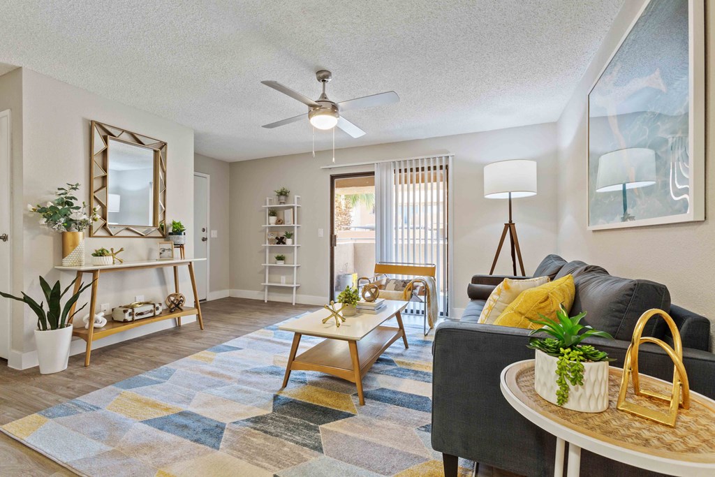 a living room with a couch and a ceiling fan