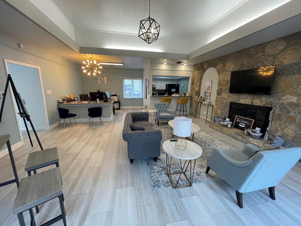 a living room with couches and chairs and a fireplace