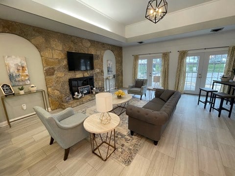 a living room with a stone wall and a couch