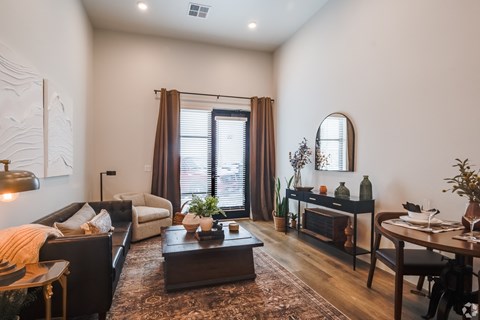 A living room with a brown coffee table and a white sofa.