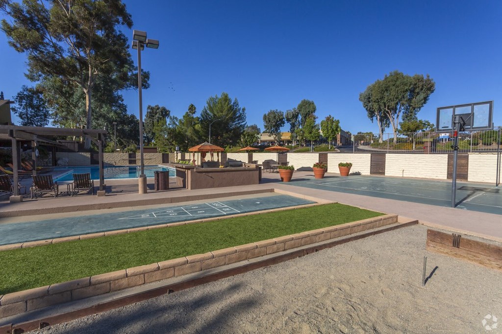 One BR Apartments in El Cajon CA - Ivanhoe Village - Outdoor Amenities Featuring Shuffleboard, Horse Shoes, Basketball Court, and the Pool