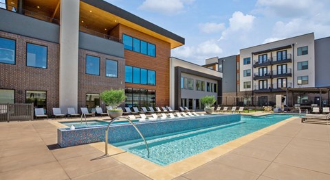A large swimming pool in front of a modern building.