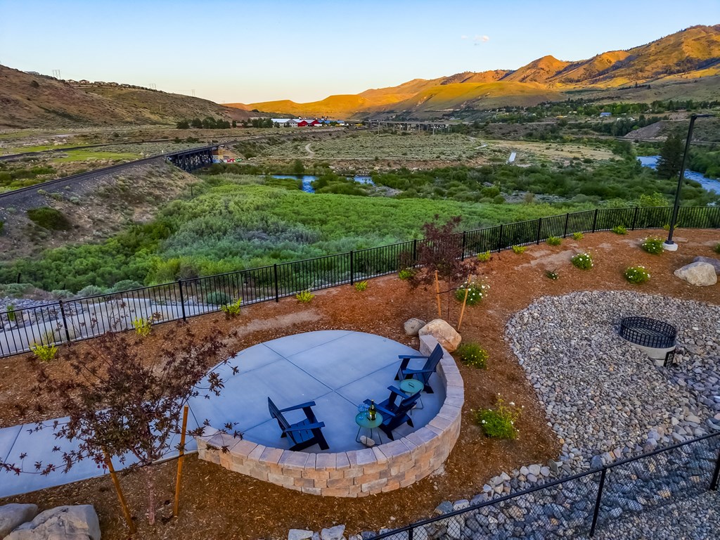A backyard with a fire pit and a picnic table.