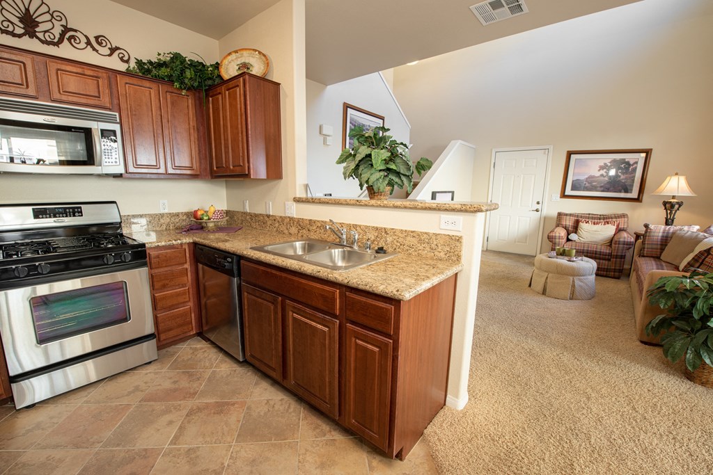 a kitchen with a sink and oven and a counter top