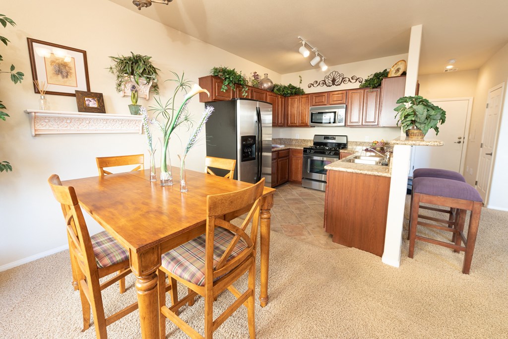 a kitchen and dining area with a wooden table and chairs