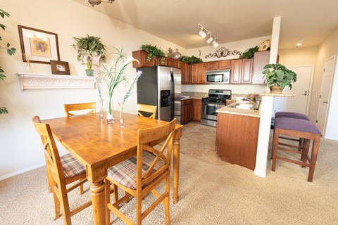 a kitchen and dining area with a wooden table and chairs