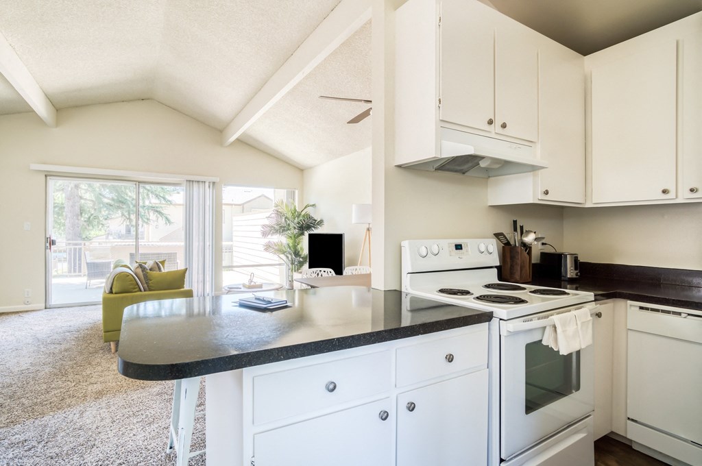 Apartments in Walnut Creek, CA for Rent - Westcliffe Trails - Kitchen with White Cabinets, White Appliances, and Black Countertops