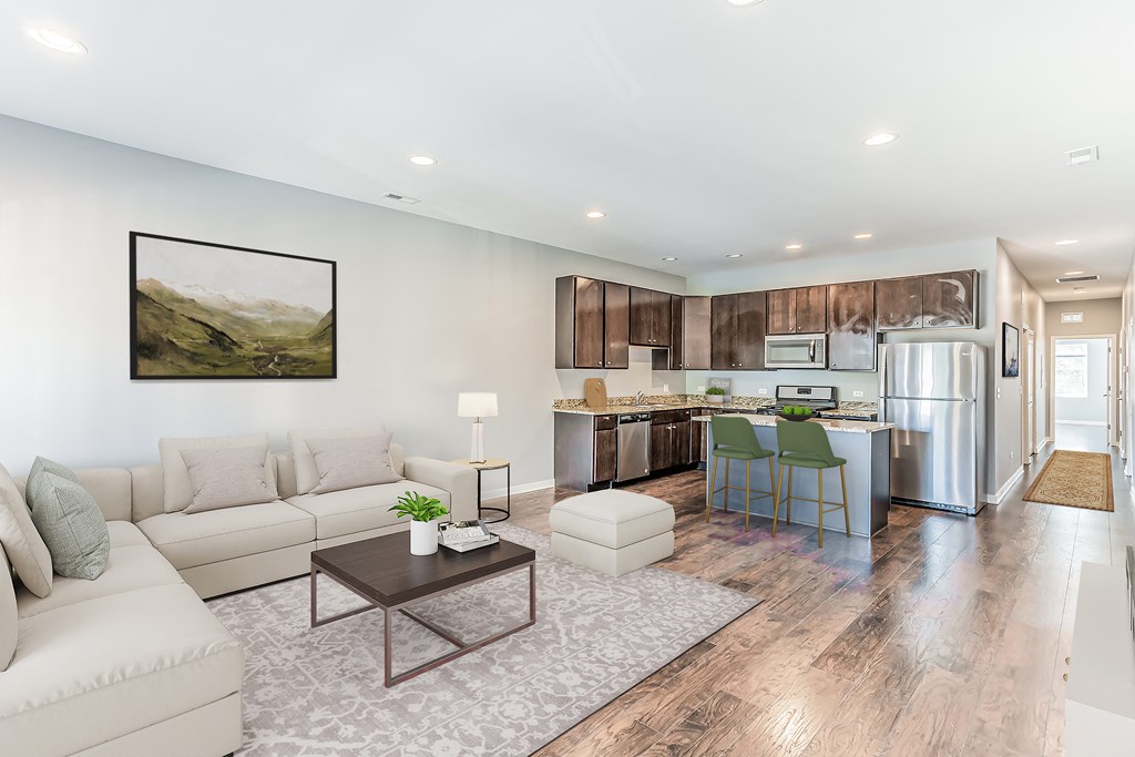 a living room and kitchen with a couch and a table