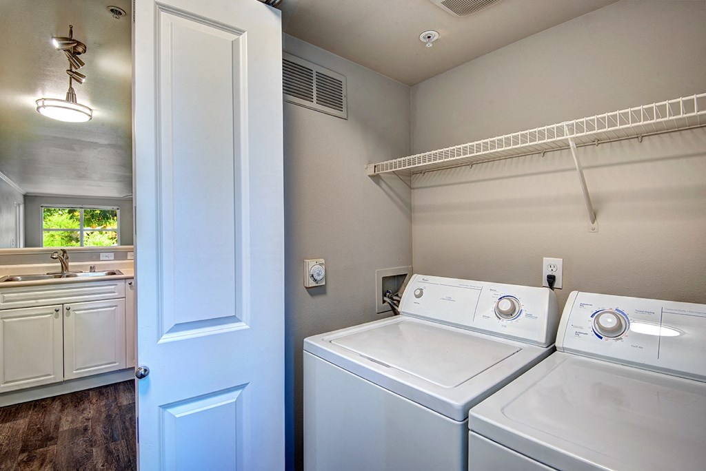 Three-Bedroom Apartments In Issaquah, WA - Langara - Laundry Closet Next To Kitchen With Full-Size Washer And Dryer, And A Storage Rack